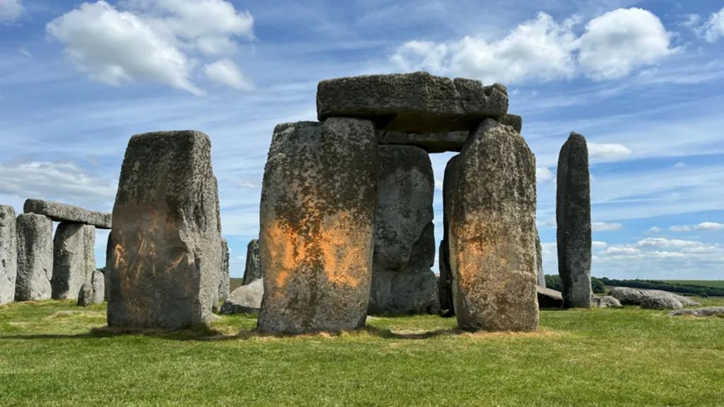Just Stop Oil activists spray orange powder on Stonehenge in peaceful climate protest.